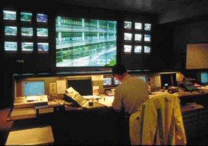 Airport landside control centre with surveillance system workstations and closed circuit television monitors. The incident detection and diversion component integrates with various operational systems of the airport.