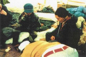 Mollard interpreting air photos inside an Inuit tent on Somerset Island in 1976.