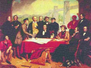 An imaginary scene painted by portrait artist John Lucas depicting "a meeting of the engineers involved in Robert Stephenson's Britannia Bridge." Stephenson is seated at centre and Alexander M. Ross is standing on the extreme right of the painting. Seated in front of Ross is the legendary Victorian engineer, Isambard Kingdom Brunel. Image reproduced by permission of the Institution of Civil Engineers.