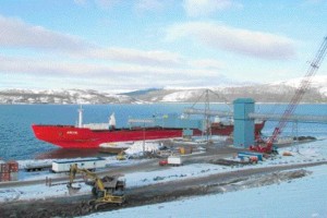 Loading nickel concentrate onto the icebreaker MV Arctic at the wharf; the shiploader is supported within one of the four circular sheet pile structures that make up the wharf.