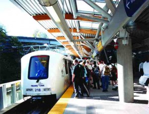 Passengers board a light rapid transit (LRT) train at the Commercial SkyTrain Station in Vancouver.