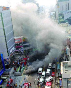 Smoke billows into a street in Daegu city, South Korea during a fatal subway fire, February 18, 2005.