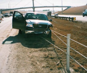 Pick-up truck stopped by a high tension median cable barrier on Deerfoot Trail.