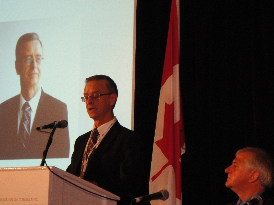 Murray Thompson, incoming chair of ACEC-Canada speaks at the annual summit in P.E.I. (left).  Outgoing chair Herb Kuehne is at right.