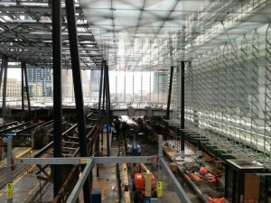Construction photograph of the "glass jewel box" being inserted in the train shed roof at Union Station in Toronto. Photograph courtesy Zeidler Partnership Architects.